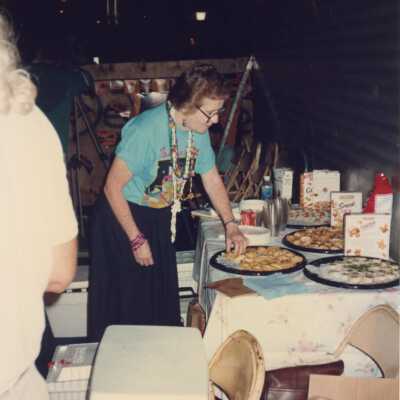 Unknown woman picking up finger foods.