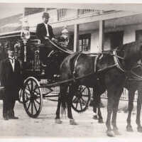 Horse-drawn hearse and two men