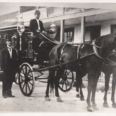 Horse-drawn hearse and two men