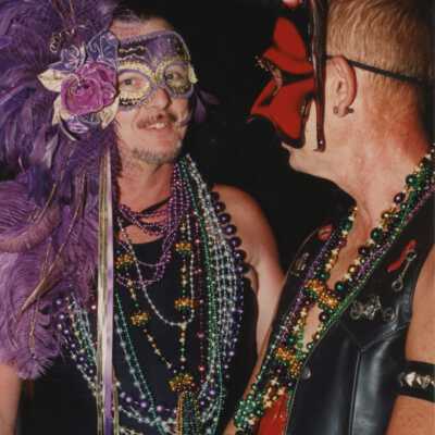 Unknown man dressed up standing under a monster.