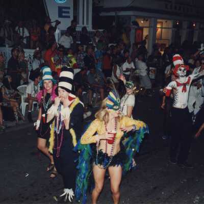 Unknown people dressed up walking on the street for the parade.