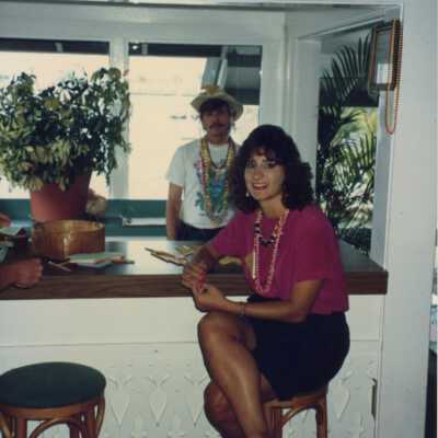 Unknown woman sitting at a bar with an unknown man behind her.