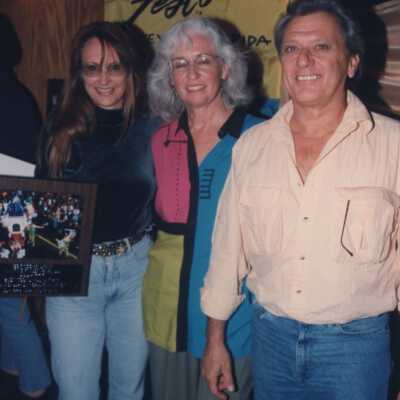Unknown people accepting an award at the award ceremony.