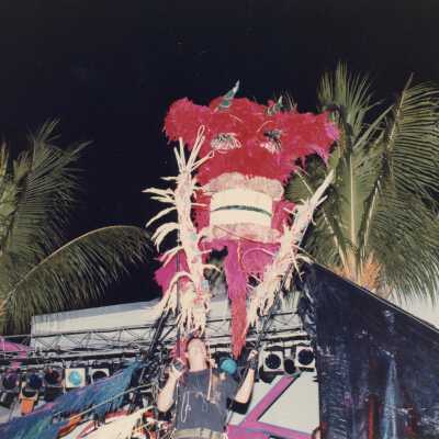 An unknown man holding some sort of costume.