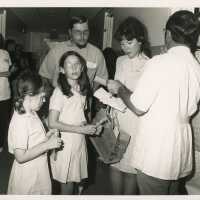 A group of unknown people standing around
