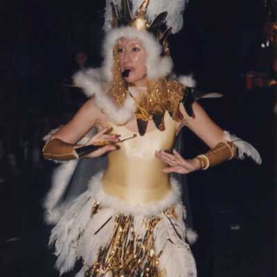 Unknown woman dressed up walking in the parade.