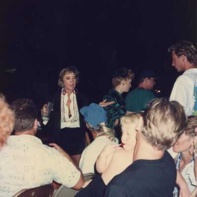 Unknown lady talking to people sitting down.