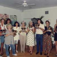 A group of unknown people accepting a trophy.