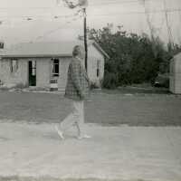 An unknown man walking down a street