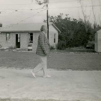 An unknown man walking down a street