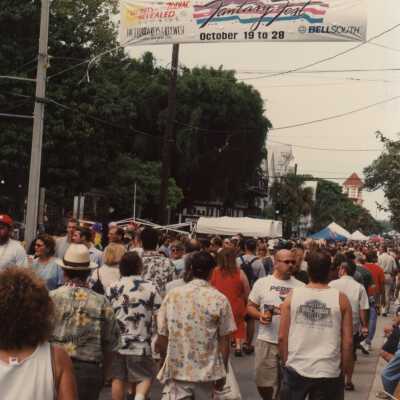 Unknown people just walking around for the street fair.