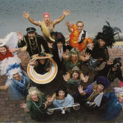 A group of unknown people dressed up looking up at the camera.