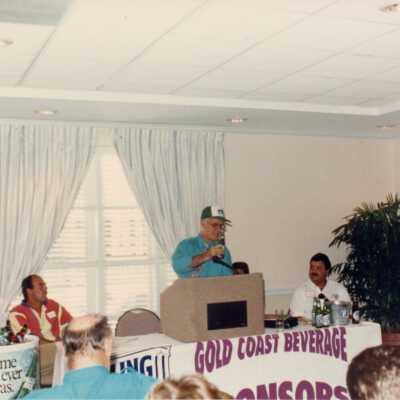 Unknown man talking behind a podium.