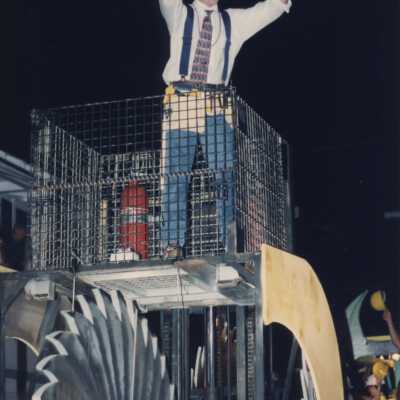An unknown man dressed up on a float for the parade.
