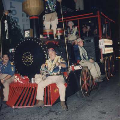 Unknown people on a float that is like a train.