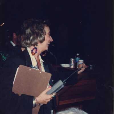 Unknown woman with a walkie-talkie in her hand.