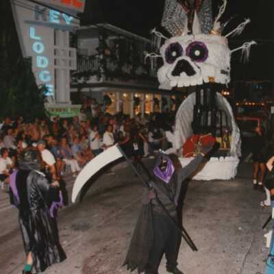 Unknown people dressed up and a float behind them.