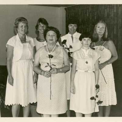 Unknown woman standing with flowers all dressed in white