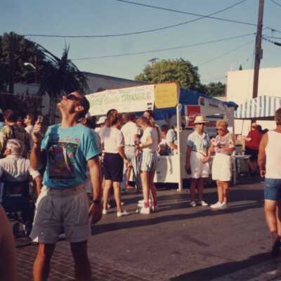 Unknown people walking in the street at the fair.