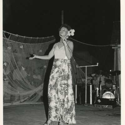 Unknown woman singing on a stage