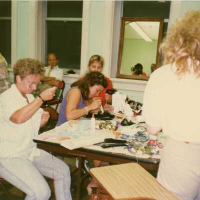 A group of unknown people making face masks.