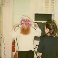 An unknown man trying on a face mask.