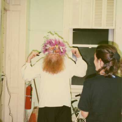 An unknown man trying on a face mask.