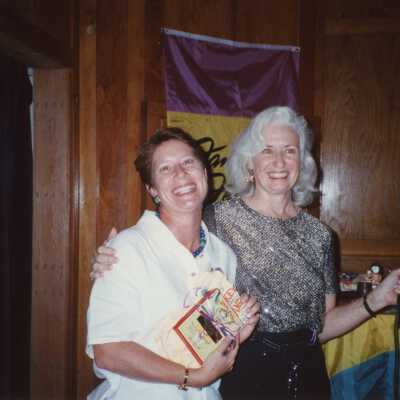 Two unknown woman at an award ceremony.