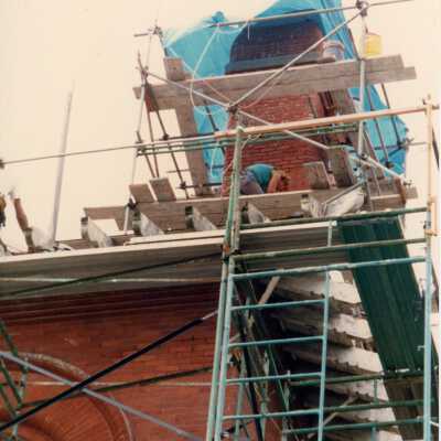 An unknown man working on the roof.