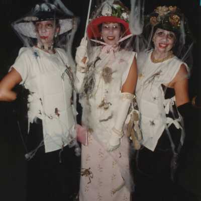 Three unknown woman dressed up.