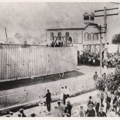 Crowd watching men on a platform