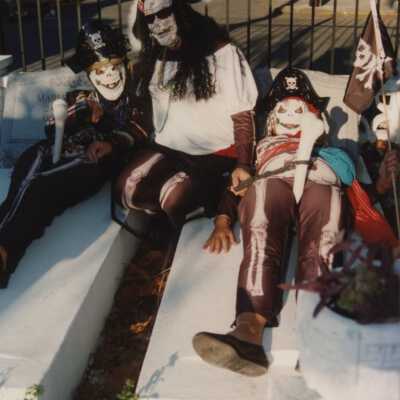 Unknown people dressed up in the cemetery.
