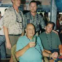 Four unknown men at a ceremony.