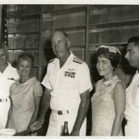 A group of unknown people at a party, a few in uniform