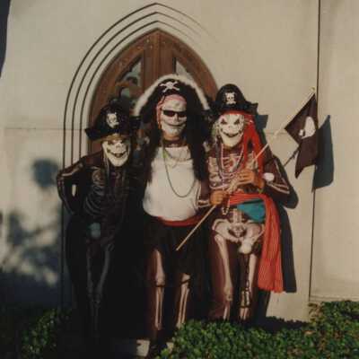 Unknown people dressed up in the cemetery.
