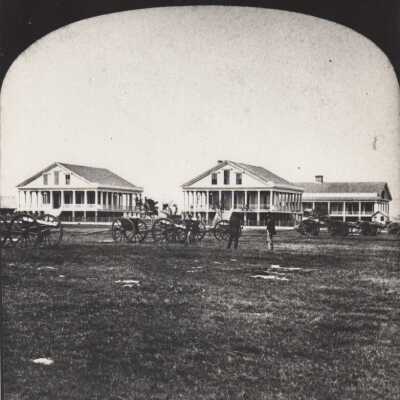 Men and cannons in front of the Army Barracks