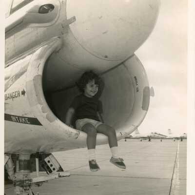 A U.S. navy jet with a child sitting inside