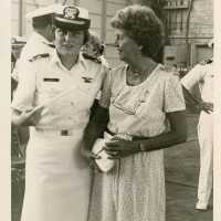 A lady in uniform standing with a woman