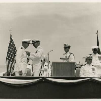 An unknown man in uniform receiving a metal