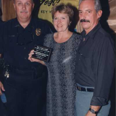 Unknown people accepting an award at the award ceremony.