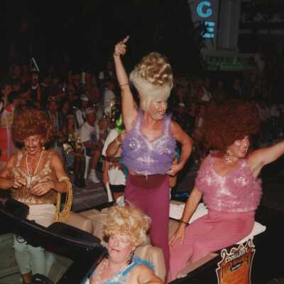 Unknown people dressed up on a float in the parade.