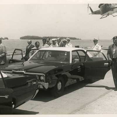 U.S. Navy base with cars and helicopters