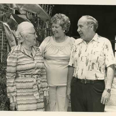 3 Unknown people standing talking