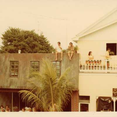 Unknown people sitting on the top of houses