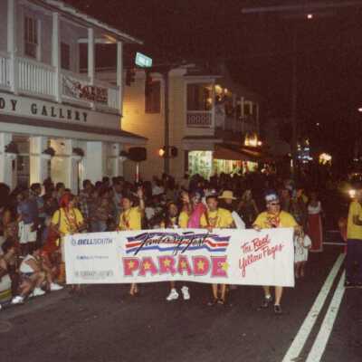 Unknown people holding the fantasy fest banner.