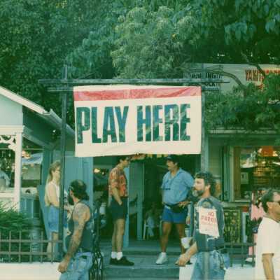 A sign that reads play here.