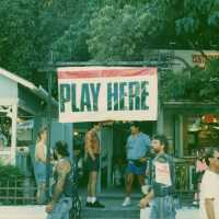 A sign that reads play here.