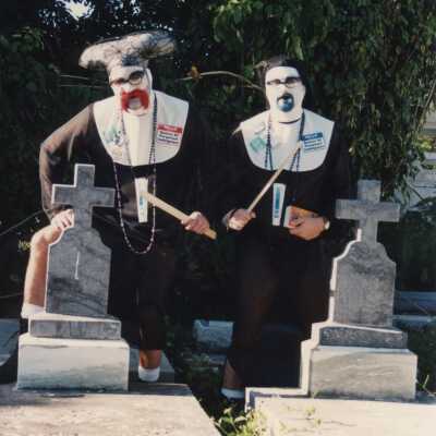 Unknown people walking near the cemetery.