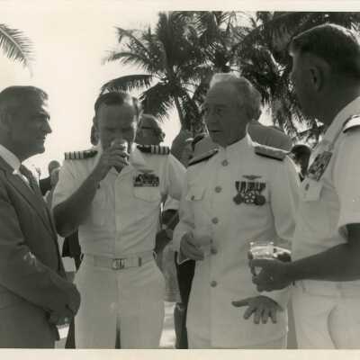 Men in uniform talking at a party