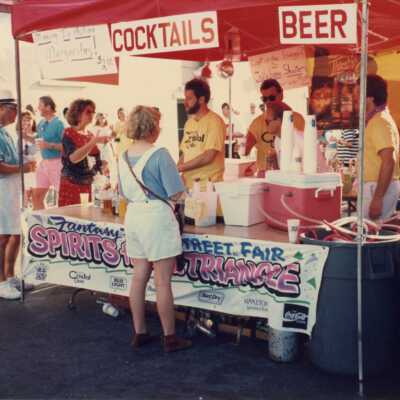 Unknown people working a cocktail booth.